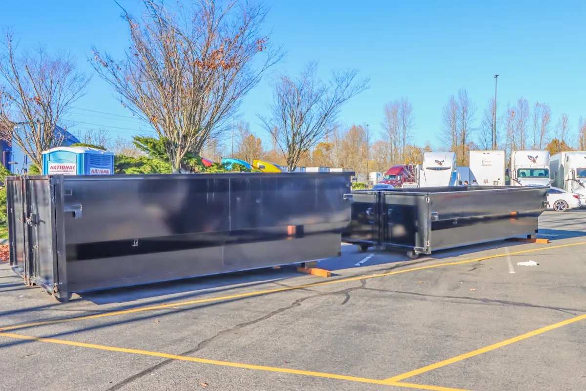 Professional dumpster rental service with roll-off container on residential driveway in Collingdale